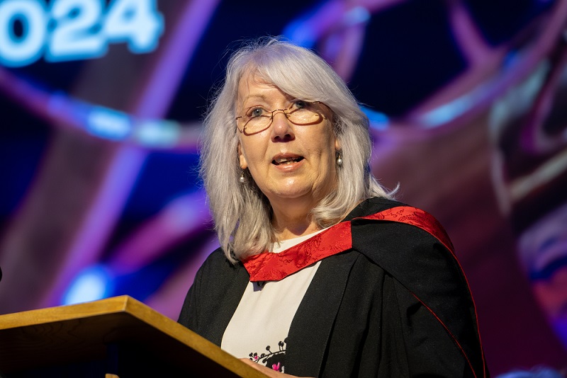 Close up of Elaine Munro speaking at graduation