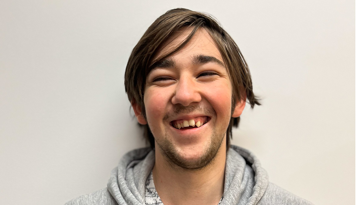 Head shot of Jordan Fenly, young man with dark hair and big smile