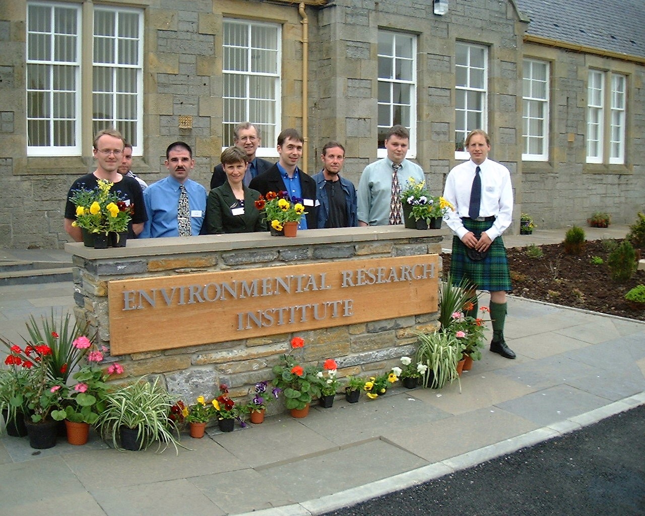 Group of people standing in front of the Environmental Research Institute sign