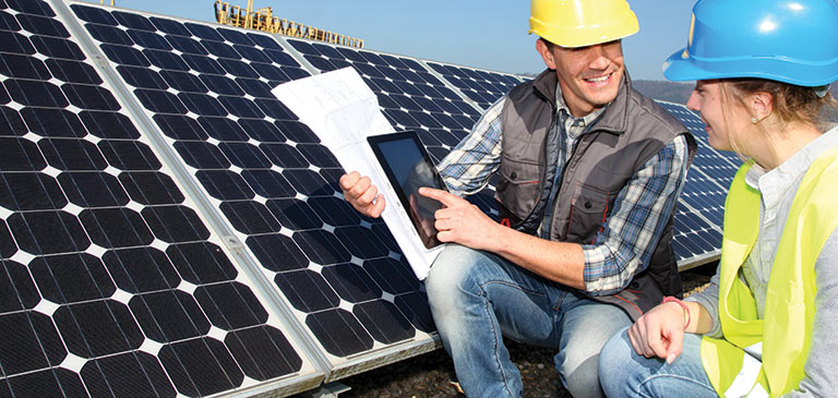 Students in front of solar panels