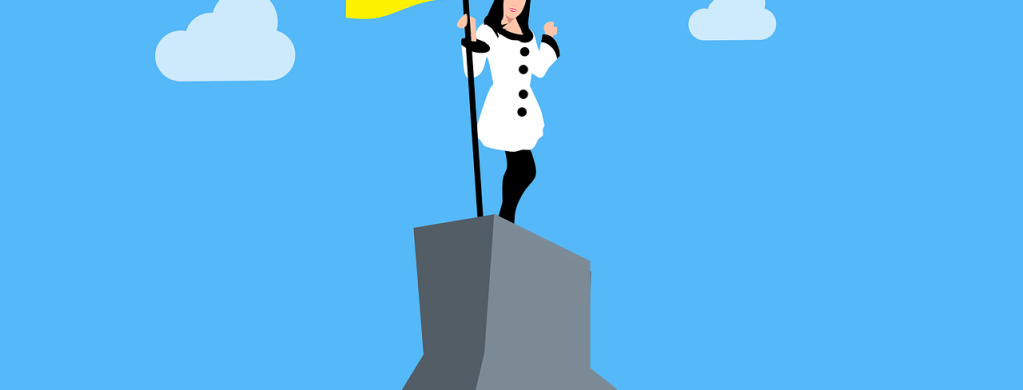 A person holding a flag on a plinth