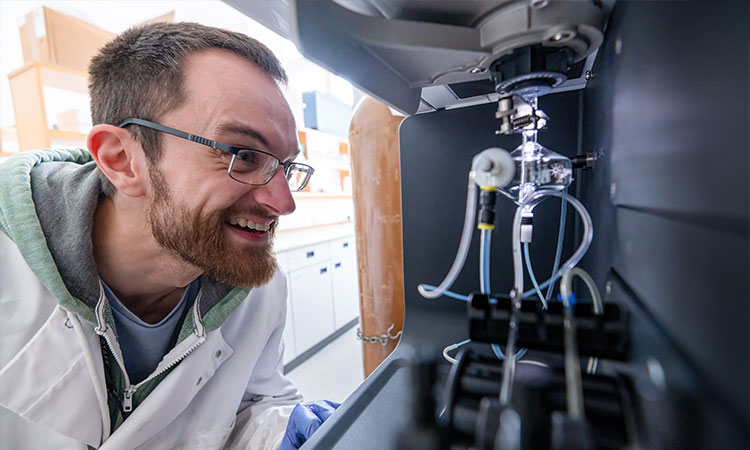 Scientist using robotic laboratory equipment