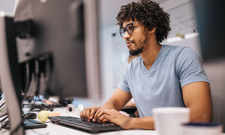 Distance researcher working at a desktop computer