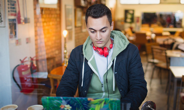 Student working on their application in a café