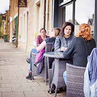 People sitting in an outside Cafe area