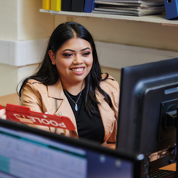 Nurina at the computer desk on campus at UHI Perth